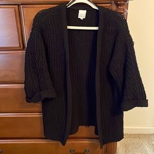 Black cardigan, slightly shorter sleeves, longer length.